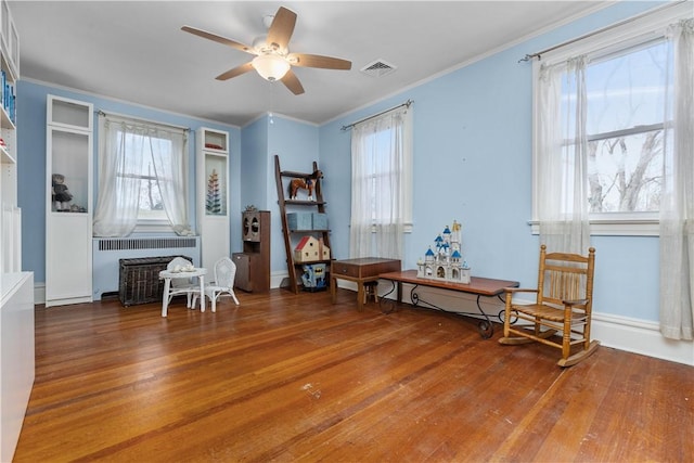 2515 Middle Rd, Hampton, PA 15116 - living area with radiator, a ceiling fan, wood finished floors, and crown molding