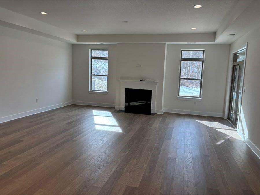 111 Hemingway Ln, Kennedy Twp, PA 15108 - unfurnished living room with baseboards, recessed lighting, a fireplace with flush hearth, and dark wood-type flooring