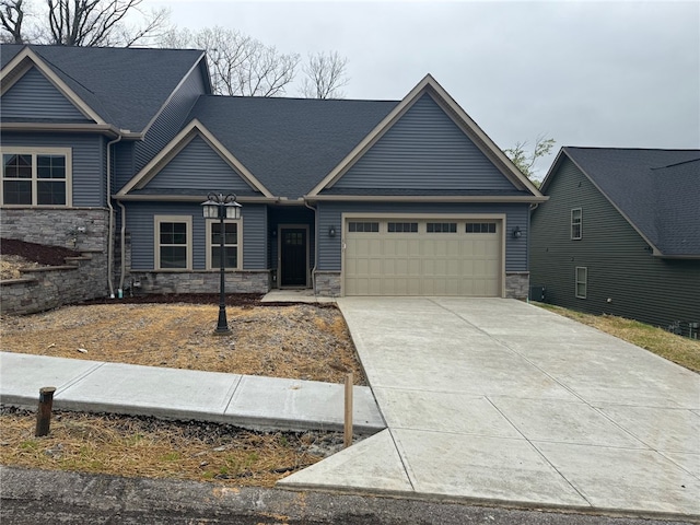 111 Hemingway Ln, Kennedy Twp, PA 15108 - craftsman-style home featuring stone siding, driveway, and a garage