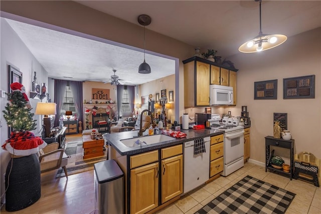 kitchen featuring pendant lighting, sink, light tile patterned floors, ceiling fan, and white appliances