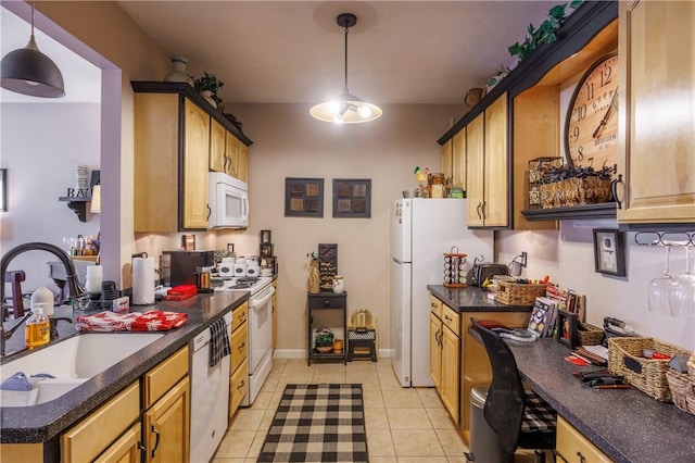 kitchen featuring white appliances, sink, hanging light fixtures, and light tile patterned floors