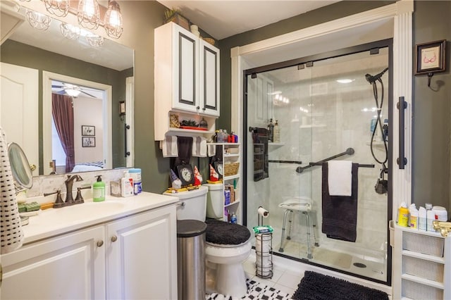 bathroom with vanity, a shower with shower door, and toilet