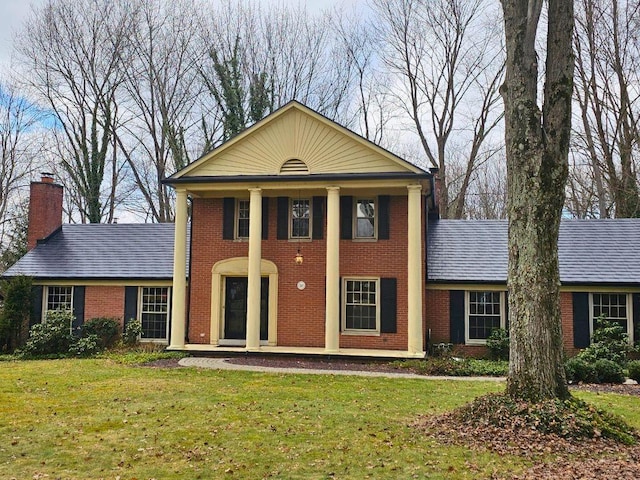 greek revival inspired property with a front lawn