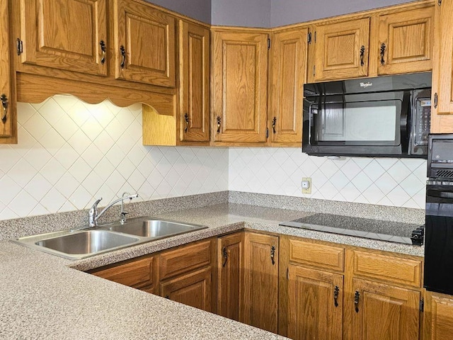 kitchen featuring sink, decorative backsplash, and black appliances