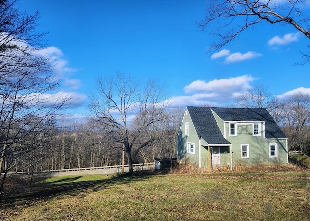 view of side of property with a lawn