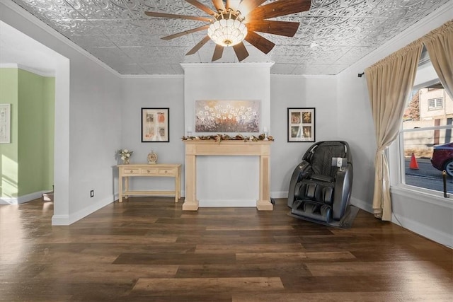 unfurnished room with crown molding, dark wood-type flooring, and ceiling fan