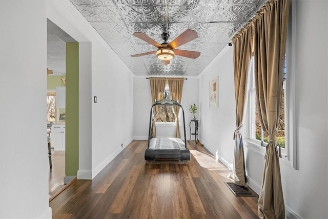 interior space featuring a healthy amount of sunlight, dark wood-type flooring, and ceiling fan