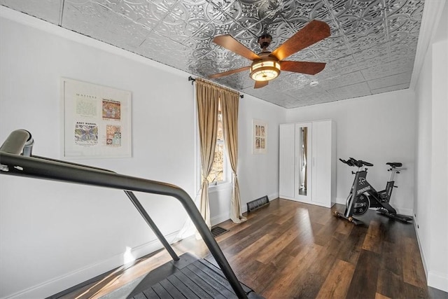 exercise area with dark hardwood / wood-style flooring and ceiling fan