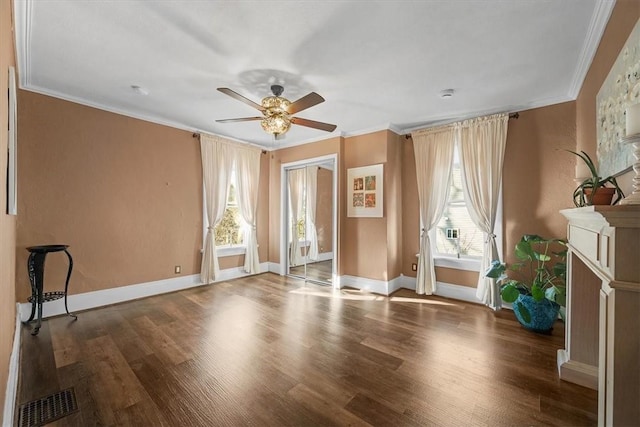 interior space with hardwood / wood-style flooring, ceiling fan, and ornamental molding