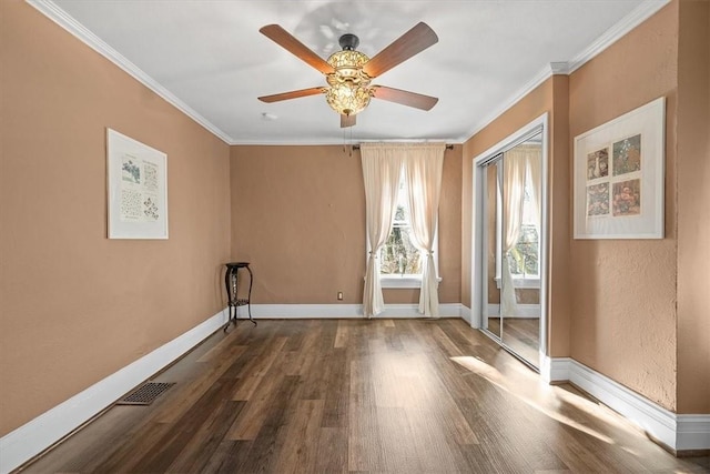 spare room featuring ornamental molding, dark hardwood / wood-style floors, and ceiling fan