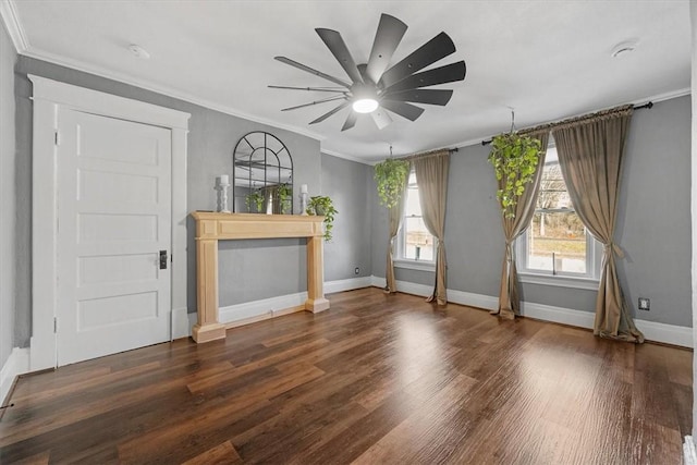 unfurnished living room featuring crown molding, dark wood-type flooring, ceiling fan, and a fireplace