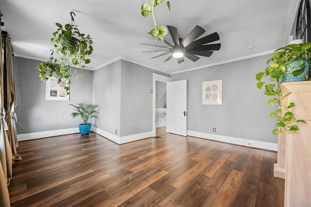 spare room featuring crown molding, dark hardwood / wood-style floors, and ceiling fan