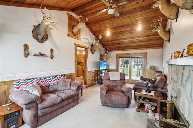 carpeted living room featuring vaulted ceiling, ceiling fan, and wood ceiling