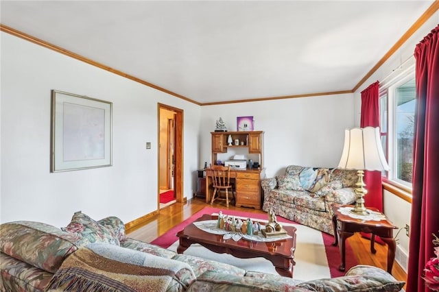 living room with ornamental molding and light hardwood / wood-style flooring