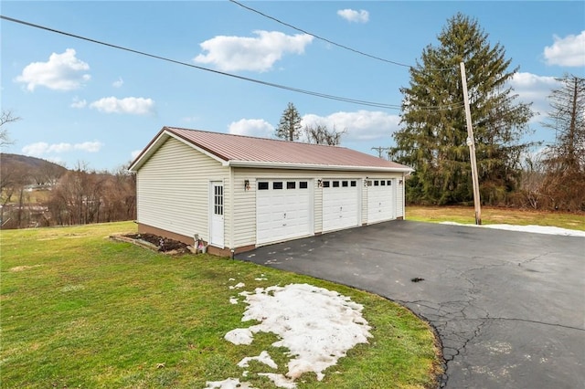 garage featuring a lawn