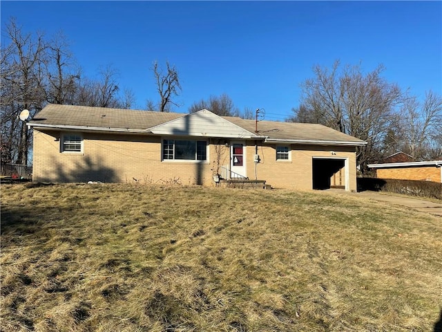 back of house with a garage and a yard