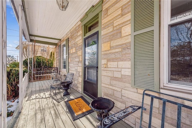 wooden terrace with a porch