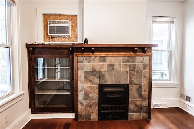 details with wood-type flooring and an AC wall unit