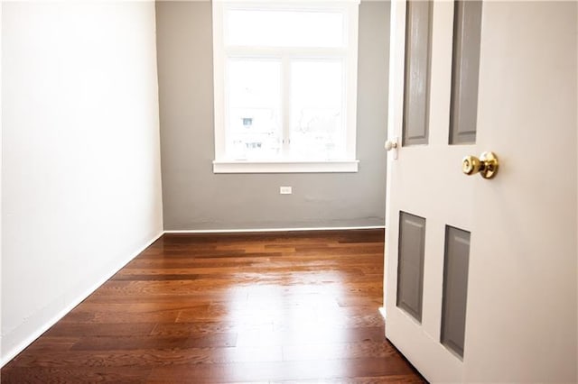 empty room featuring dark wood-type flooring