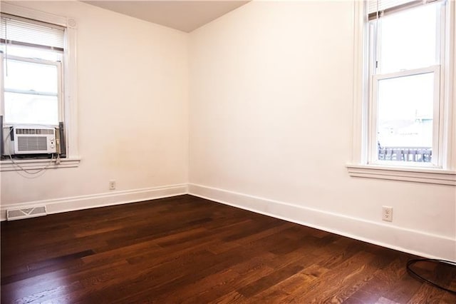 unfurnished room featuring wood-type flooring and cooling unit