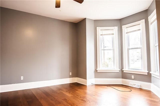 unfurnished room with hardwood / wood-style floors and ceiling fan