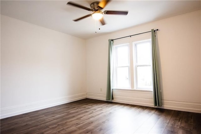 empty room with dark hardwood / wood-style flooring and ceiling fan