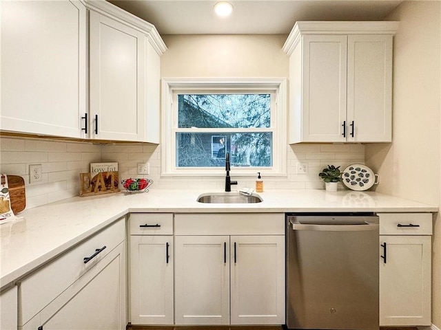 kitchen with white cabinetry, dishwasher, sink, and backsplash