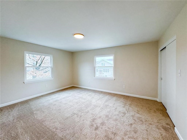 carpeted empty room with plenty of natural light