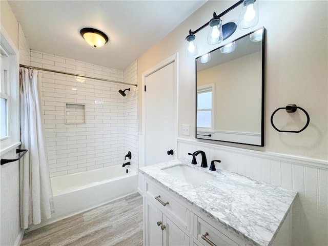 bathroom with vanity, hardwood / wood-style flooring, and shower / bath combination with curtain