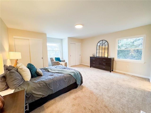 carpeted bedroom with multiple closets