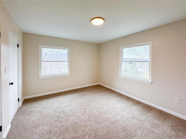 carpeted spare room with a healthy amount of sunlight