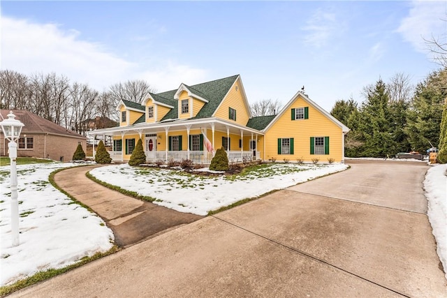 view of front of property featuring driveway and a porch