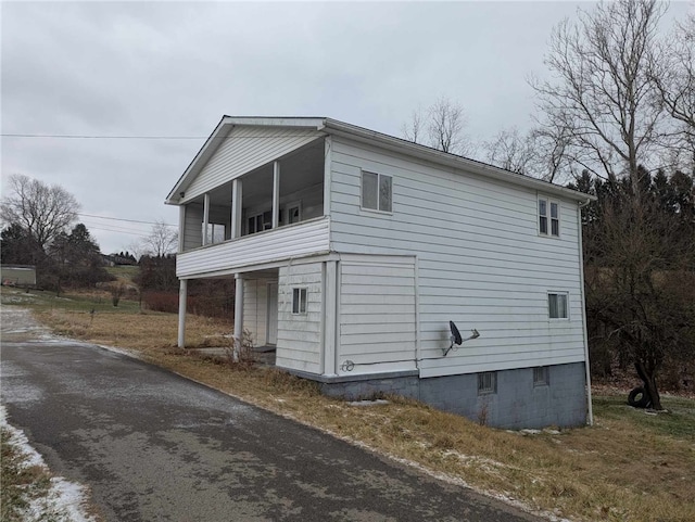 view of side of property featuring a sunroom