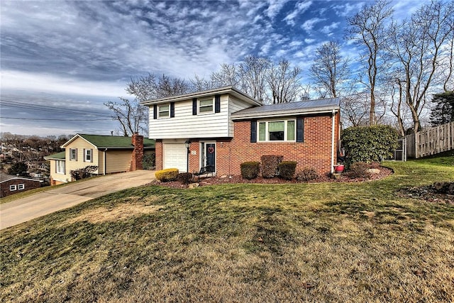 split level home with a garage and a front yard