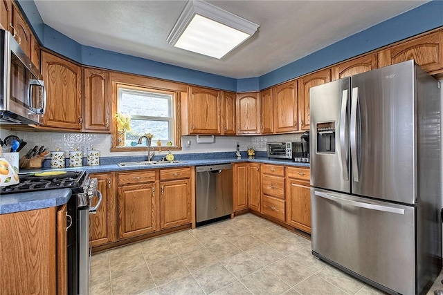 kitchen featuring appliances with stainless steel finishes, sink, and backsplash