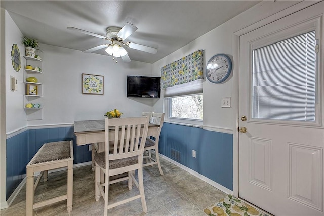 tiled dining space featuring ceiling fan