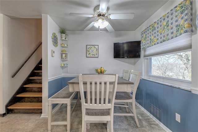 tiled dining room featuring ceiling fan