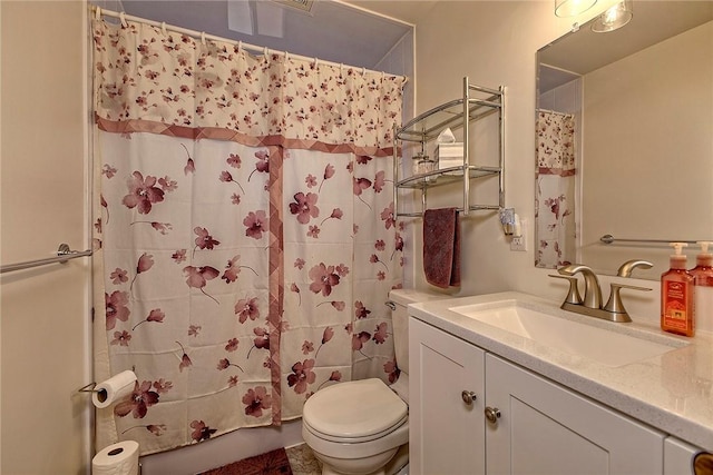 bathroom with vanity, curtained shower, and toilet