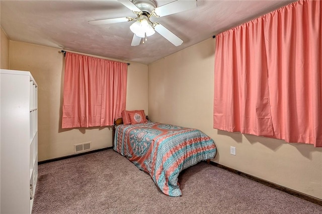 bedroom featuring ceiling fan and carpet