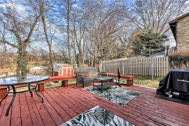 deck featuring area for grilling and a shed