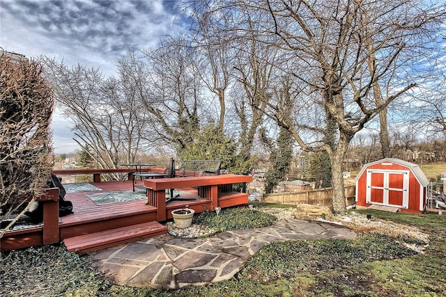 wooden deck with a storage shed