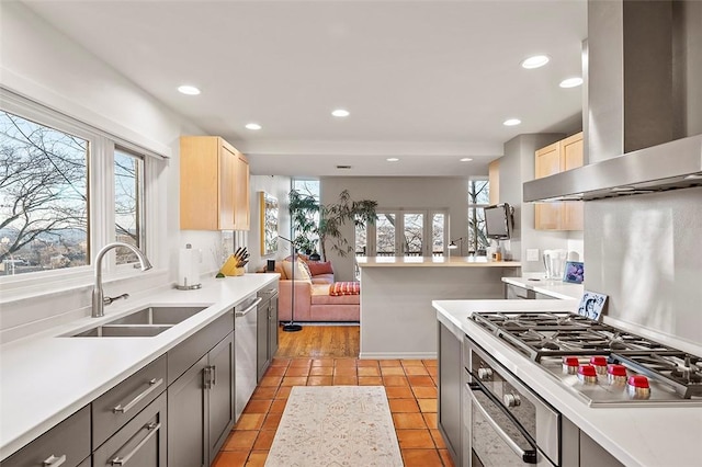 kitchen with sink, gray cabinets, stainless steel appliances, island range hood, and light tile patterned flooring