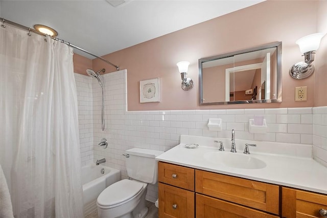 full bathroom with vanity, tile walls, shower / bath combo, and toilet