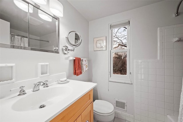 bathroom featuring vanity, toilet, and a shower with shower curtain