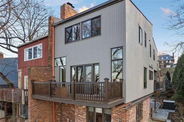 rear view of property featuring a balcony