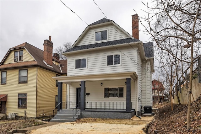 view of front of property with a porch and central AC unit