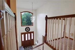 entrance foyer with an inviting chandelier and vaulted ceiling