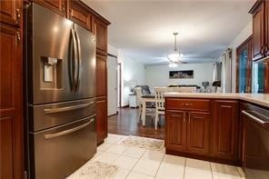 kitchen featuring stainless steel appliances and hanging light fixtures