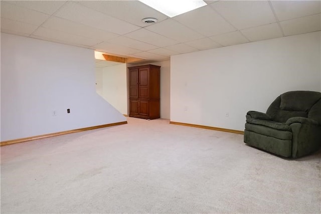 unfurnished room featuring a paneled ceiling and light colored carpet