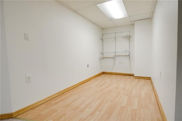 empty room featuring hardwood / wood-style flooring and a paneled ceiling